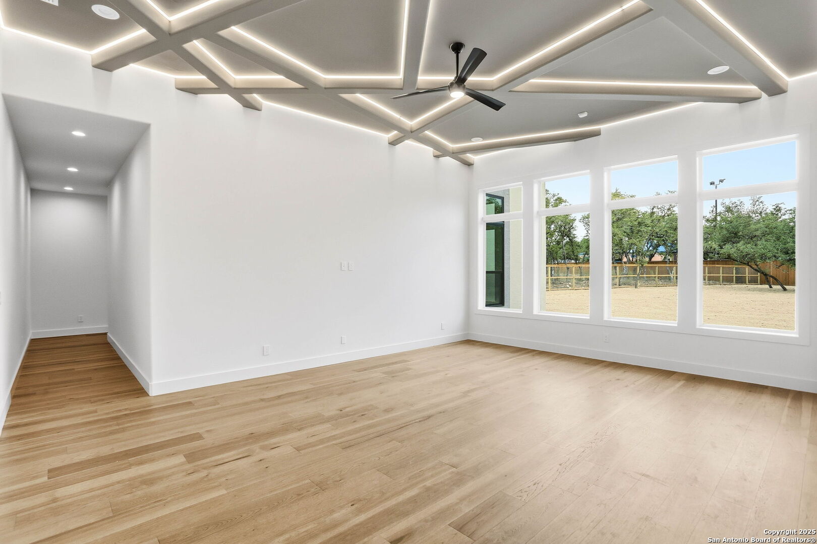 15 Wellesley Loop Shavano Park, TX 78231 - Photo 16 of 48 a view of an empty room with wooden floor and a ceiling fan