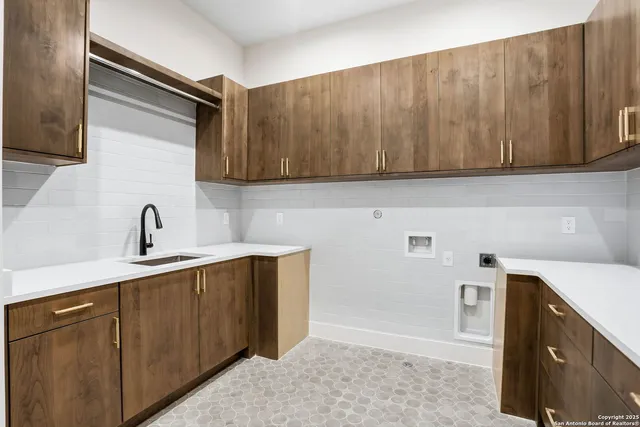 a kitchen with a sink and cabinets