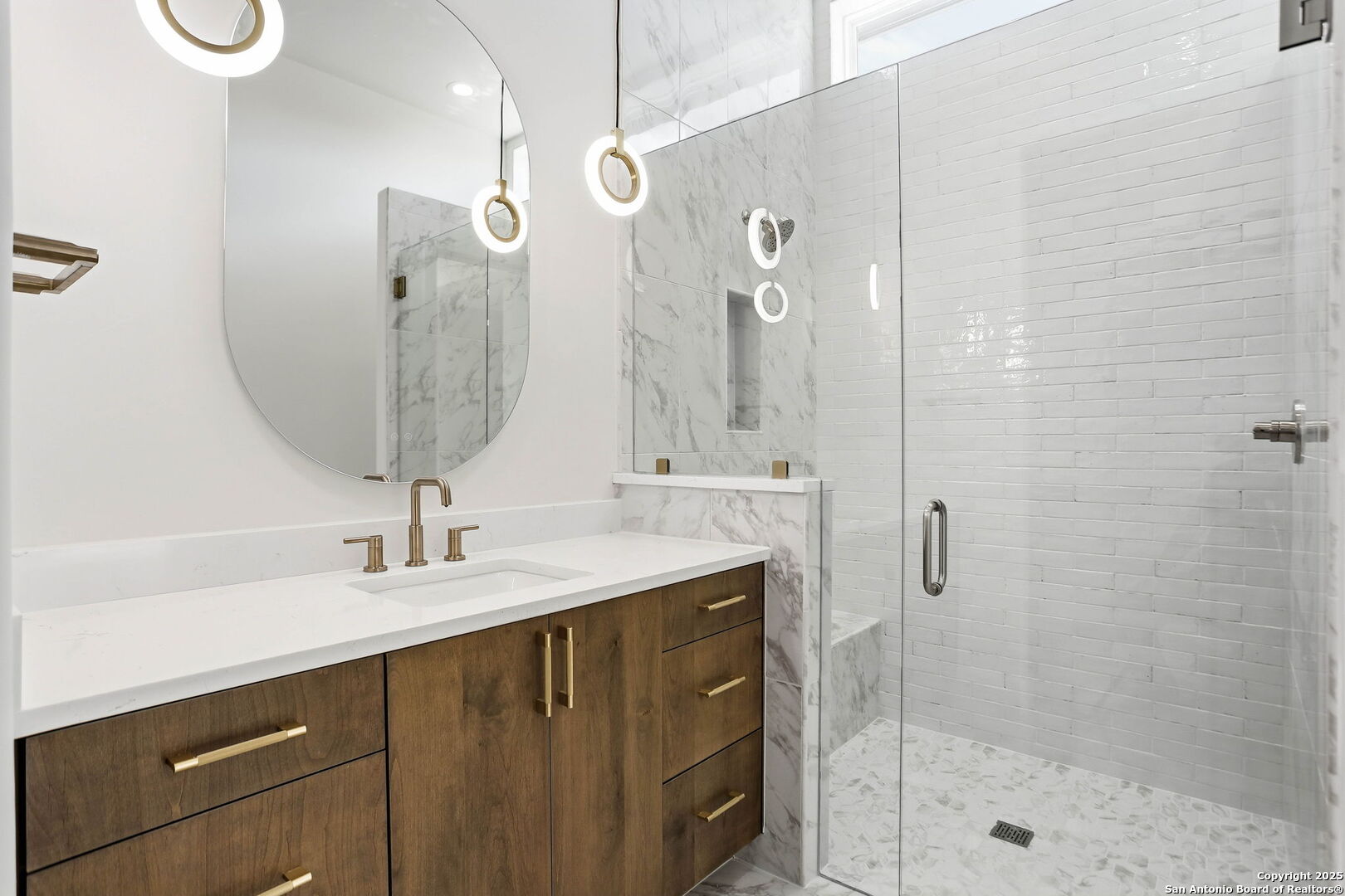 15 Wellesley Loop Shavano Park, TX 78231 - Photo 22 of 48 a bathroom with a sink a mirror a vanity and shower