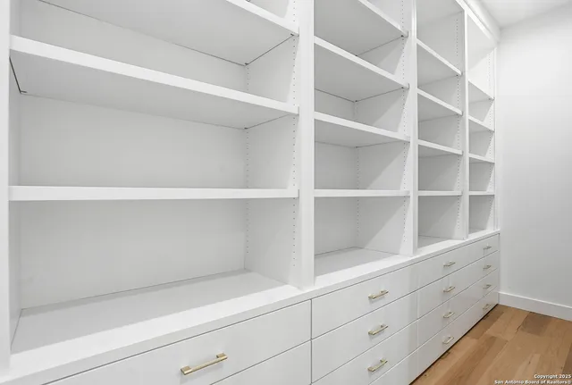 a bathroom with a tub shower and sink