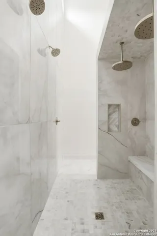 a spacious bathroom with a double vanity sink mirror and bathtub