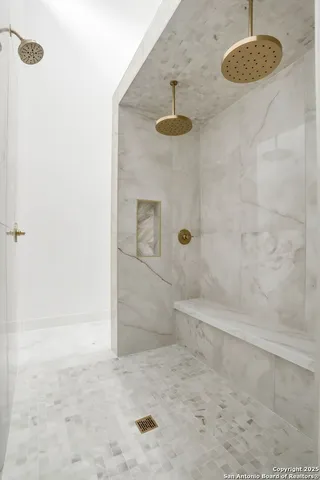 a large bathroom with a tub and shower