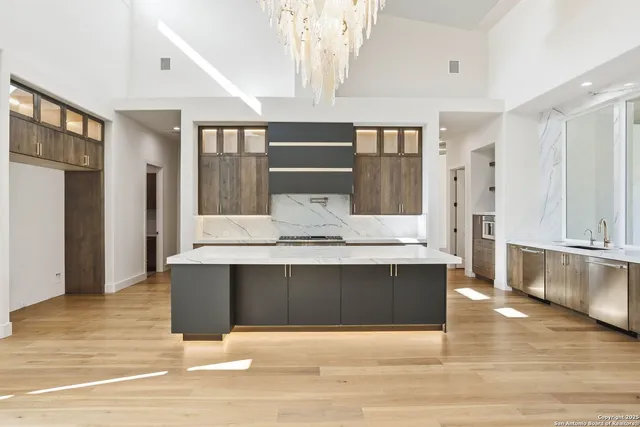 a view of spacious living room with furniture and wooden floor