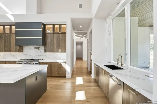 a large kitchen with a stove and cabinets