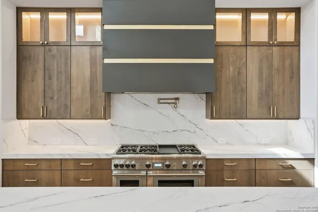a kitchen with granite countertop a stove and a refrigerator