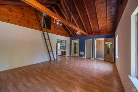 a kitchen with a wooden floor and a kitchen