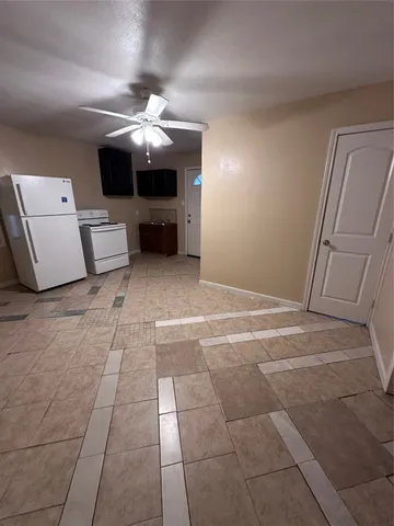 a view of a livingroom with furniture and chandelier fan