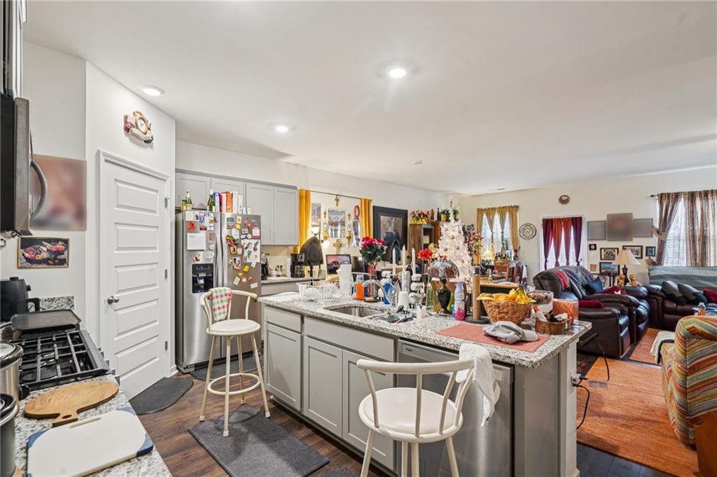 1729 Limousin Way Stockbridge, GA 30281 - Photo 5 of 18 a very nice looking living room with dining room and furniture