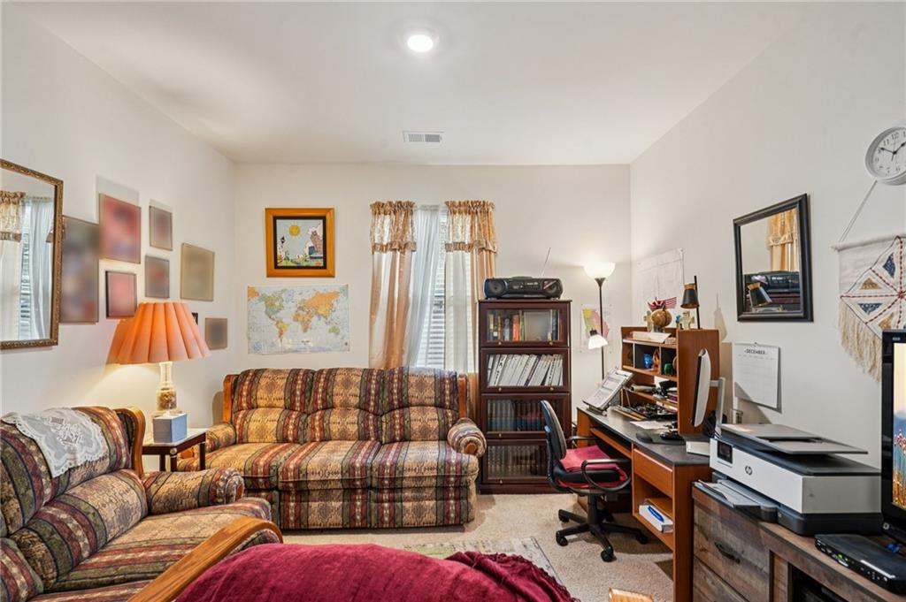 1729 Limousin Way Stockbridge, GA 30281 - Photo 7 of 18 a living room with furniture gym equipment and a flat screen tv
