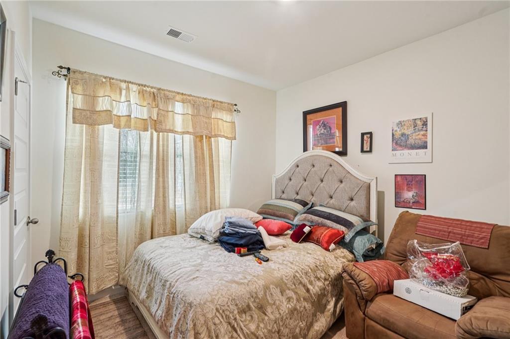 1729 Limousin Way Stockbridge, GA 30281 - Photo 8 of 18 a bedroom with a bed and a couch