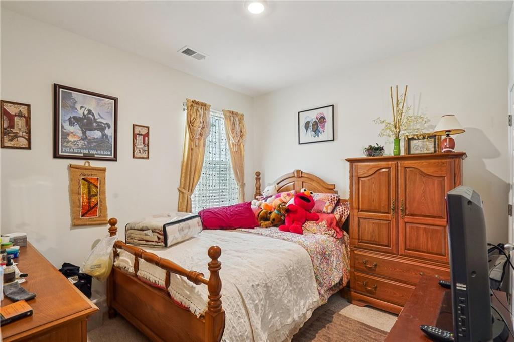 1729 Limousin Way Stockbridge, GA 30281 - Photo 10 of 18 a bed room with a bed and a television