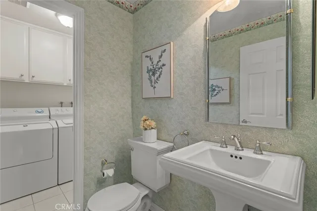 a bathroom with a sink mirror and toilet