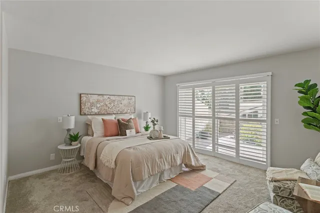 a bedroom with a large bed and a window