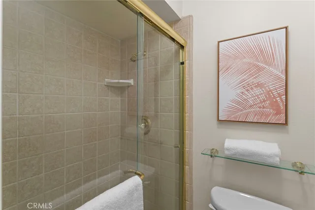 a view of a room with a ceiling fan and a window