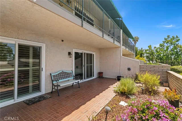 a view of a balcony with wooden floor and fence