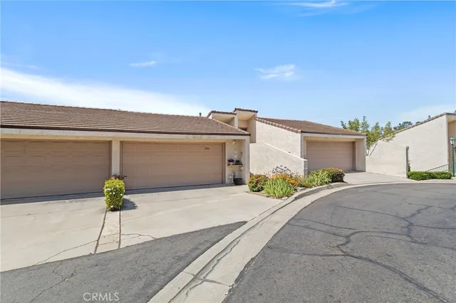 an aerial view of a house with a yard and lake view