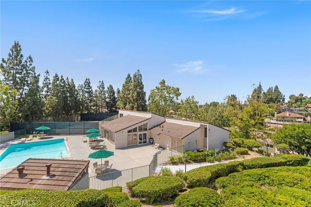 a view of house with swimming pool and sitting area