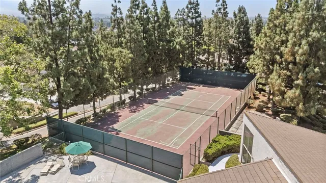 an aerial view of a house with swimming pool and porch