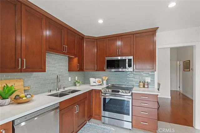 a kitchen with granite countertop wooden cabinets and white appliances