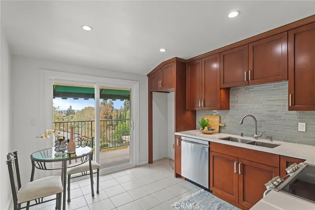 a kitchen that has a sink and chairs