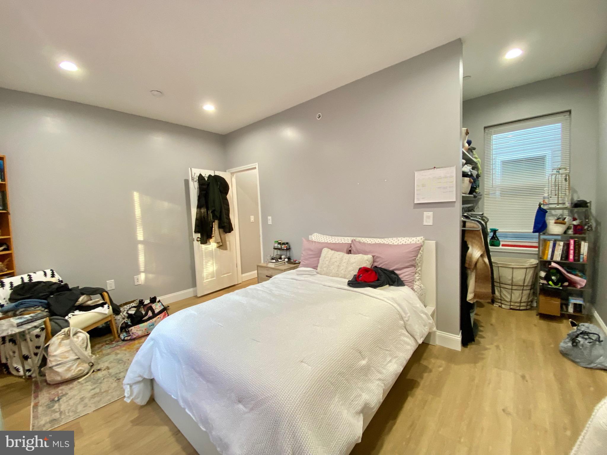 1932 North 8th Street, Unit 2 Philadelphia, PA 19122 - Photo 16 of 34 a bedroom with bed and a view of living room