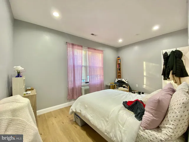 a bedroom with a bed and a large mirror