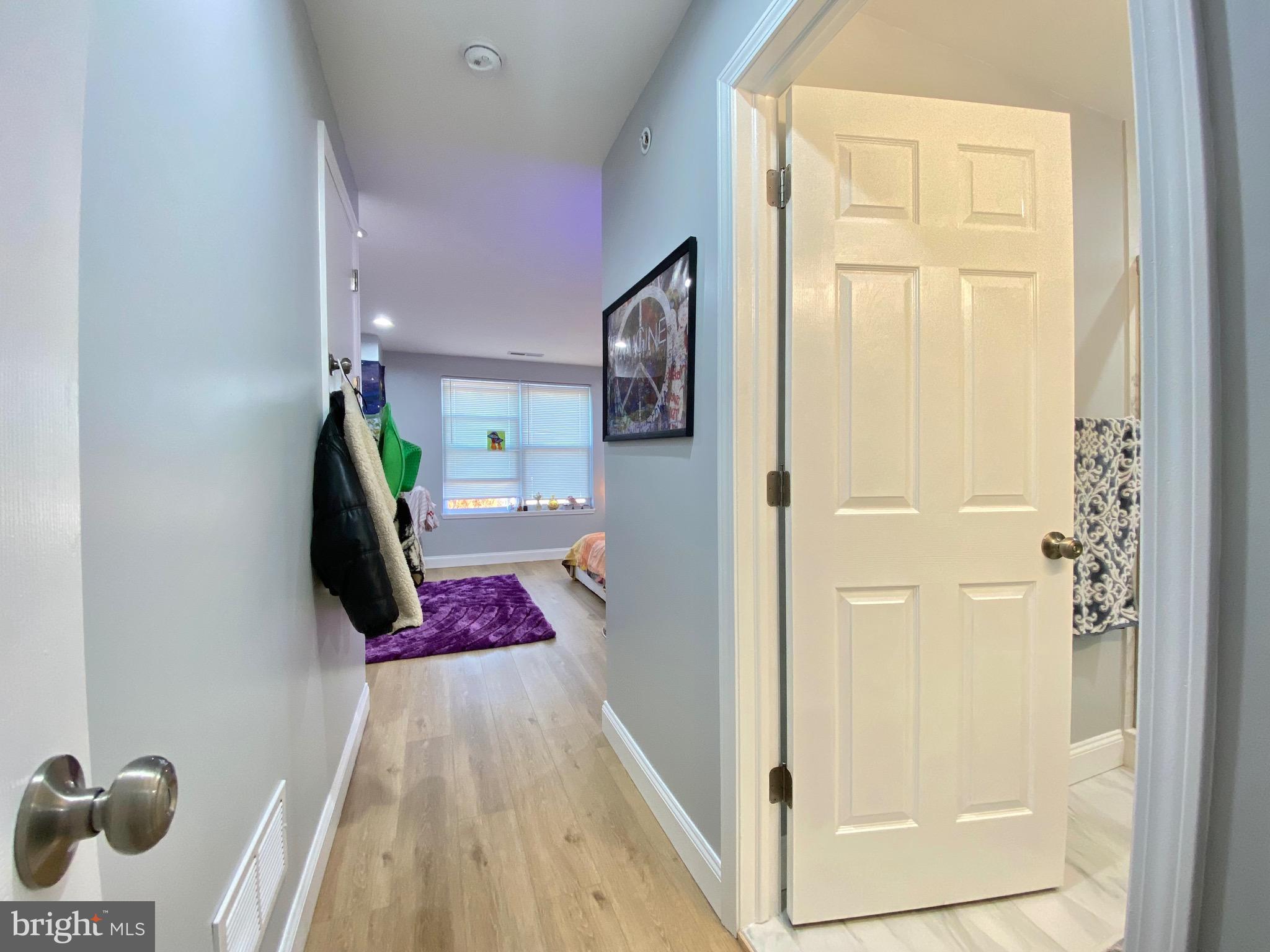 1932 North 8th Street, Unit 2 Philadelphia, PA 19122 - Photo 20 of 34 a bedroom with a bed and a mirror