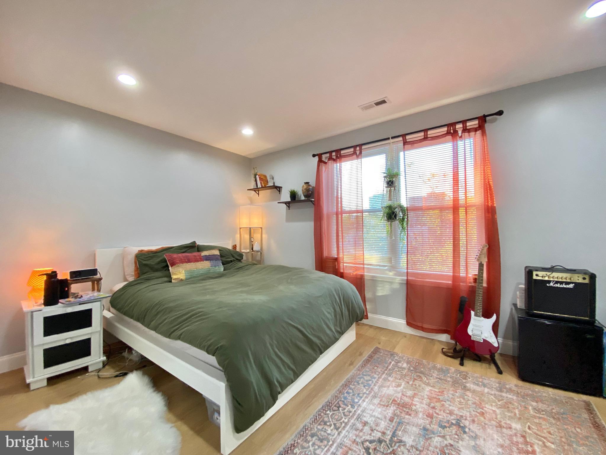 1932 North 8th Street, Unit 2 Philadelphia, PA 19122 - Photo 25 of 34 a bedroom with a bed and a window