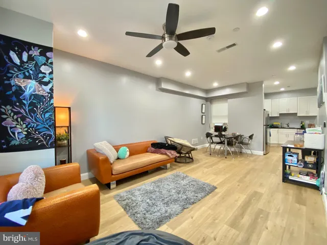 a living room with furniture and kitchen view