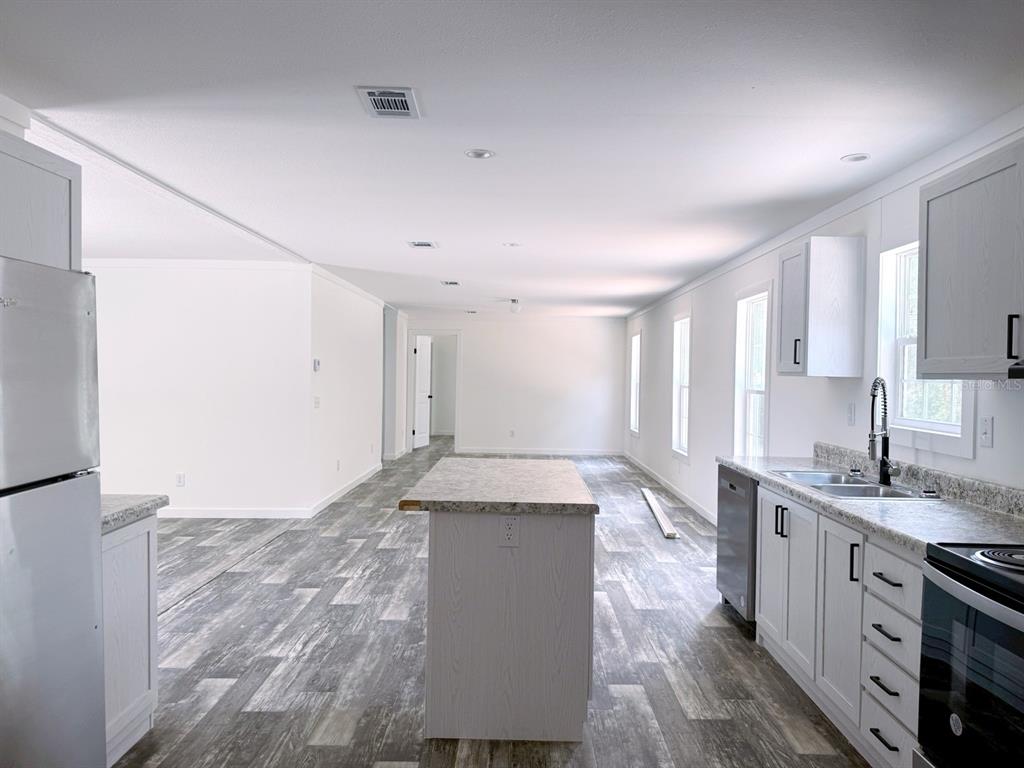 9644 North Eventide Point Crystal River, FL 34428 - Photo 4 of 18 a spacious bathroom with a granite countertop sink a toilet a mirror and vanity