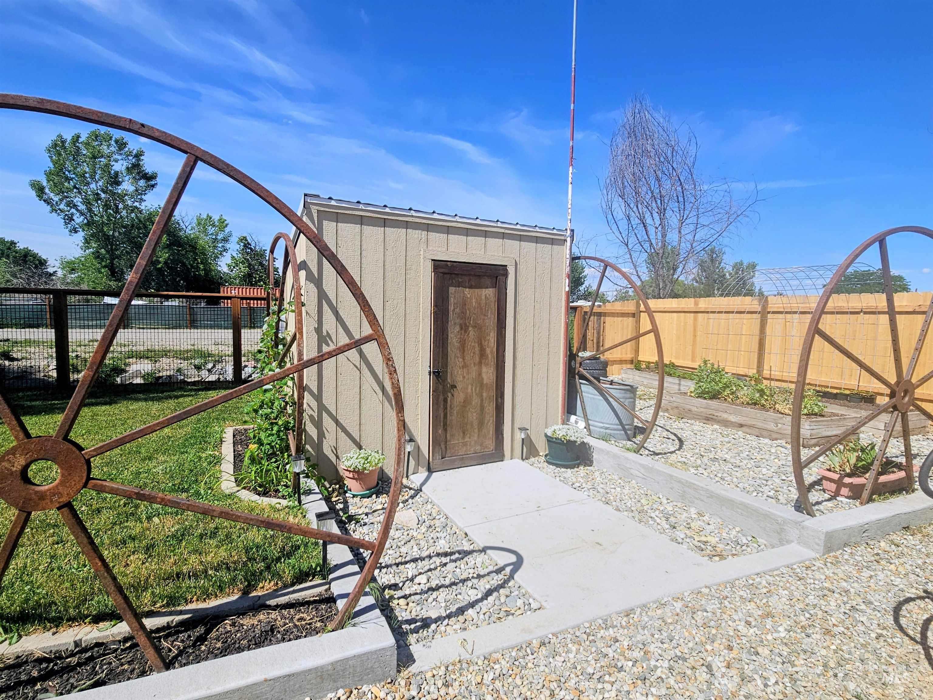 8392 Main Street Letha, ID 83636 - Photo 23 of 31 Utility shed featuring vertical siding, a solid wood door, and a metal roof