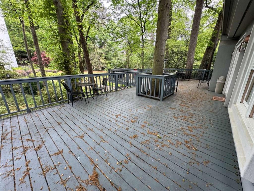 3201 Lenox Road Northeast, Unit 2 Atlanta, GA 30324 - Photo 35 of 39 a view of a balcony with wooden floor and fence