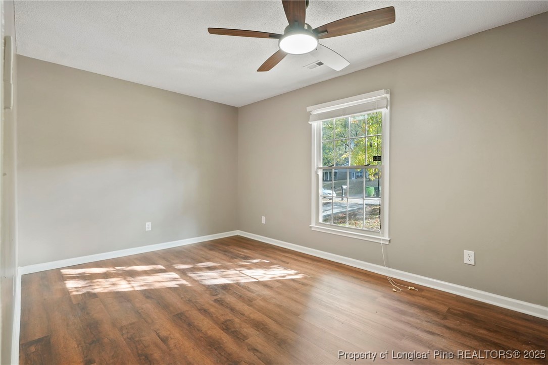 2308 Keith Drive Raleigh, NC 27610 - Photo 12 of 26 a view of an empty room with wooden floor and a window