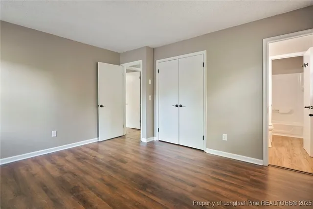 a view of an empty room and wooden floor