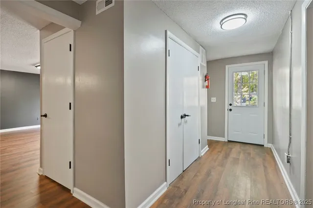 a view of hallway with wooden floor