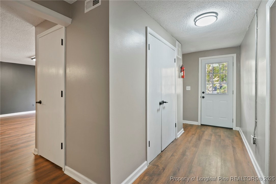 2308 Keith Drive Raleigh, NC 27610 - Photo 22 of 26 a view of hallway with wooden floor