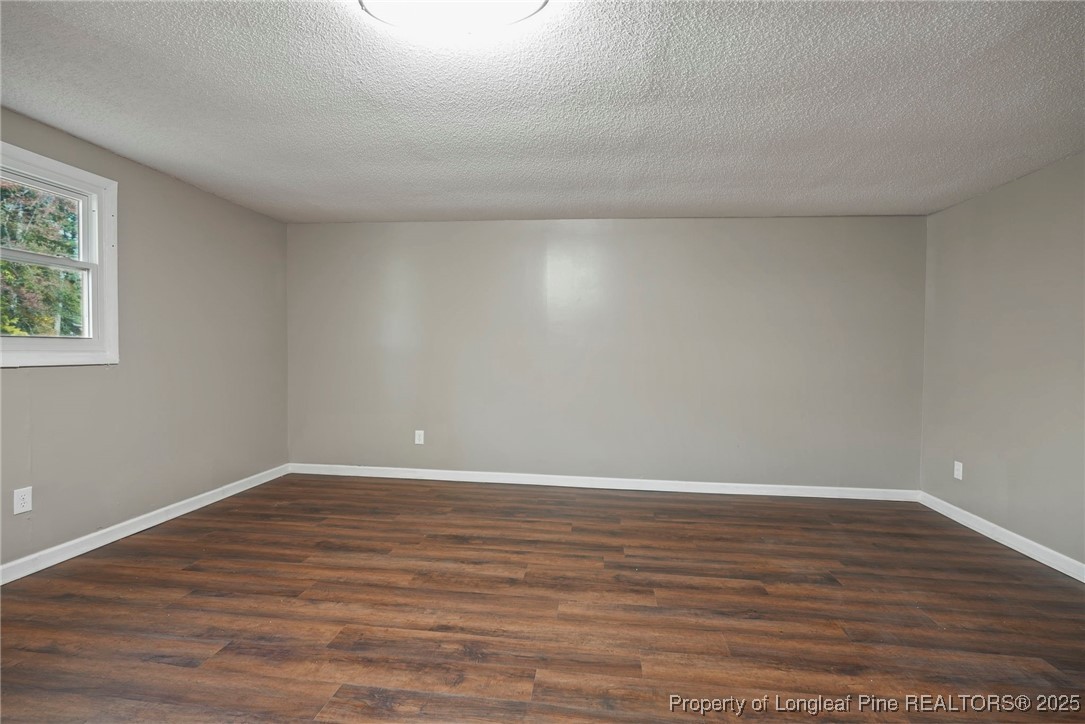 2308 Keith Drive Raleigh, NC 27610 - Photo 23 of 26 a view of an empty room with wooden floor and a window