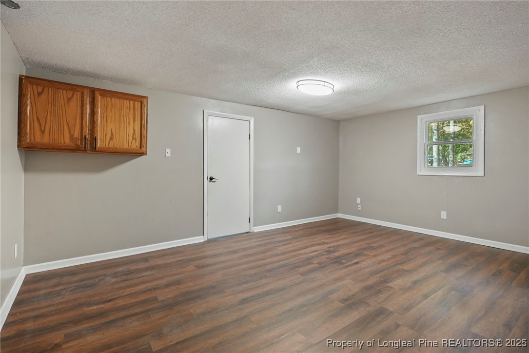 2308 Keith Drive Raleigh, NC 27610 - Photo 24 of 26 a view of an empty room with wooden floor and a window