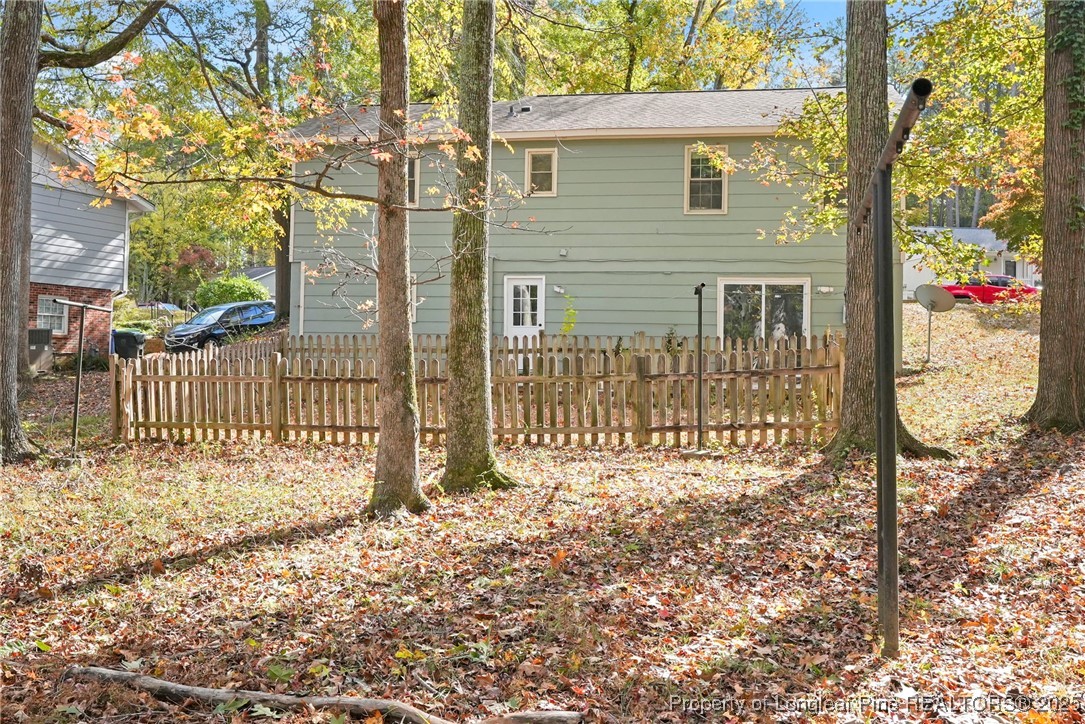 2308 Keith Drive Raleigh, NC 27610 - Photo 25 of 26 a front view of a house with a small yard and wooden fence