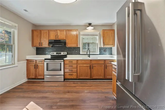 a kitchen with a sink window and cabinets