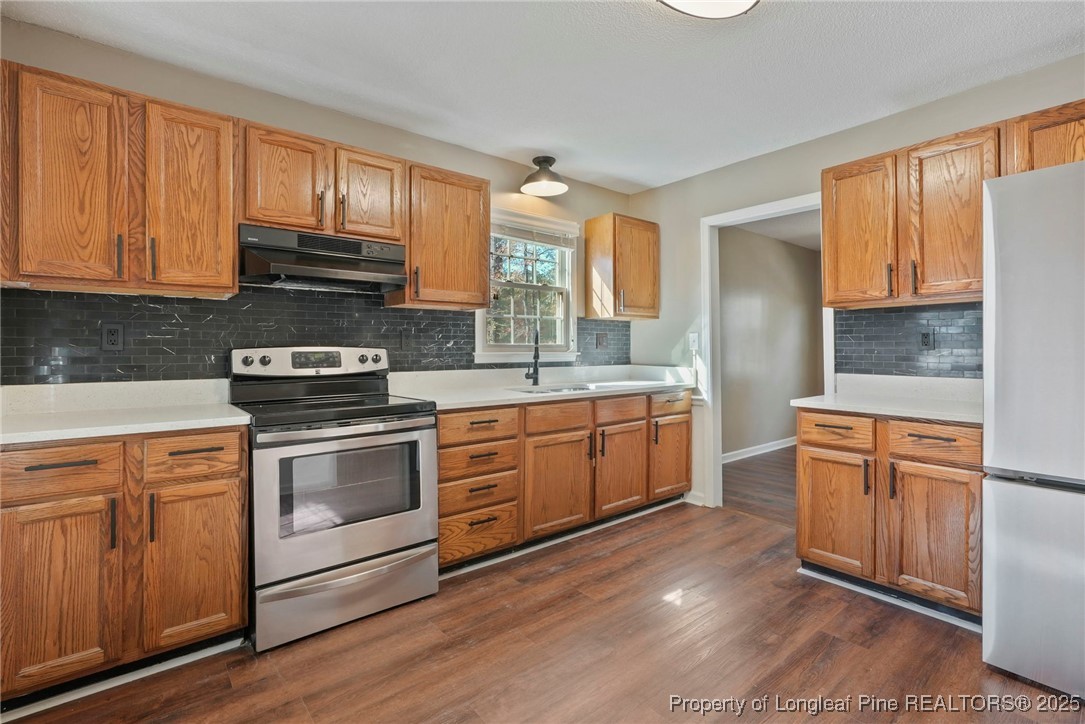 2308 Keith Drive Raleigh, NC 27610 - Photo 5 of 26 a kitchen with stainless steel appliances granite countertop a stove a sink dishwasher and a refrigerator