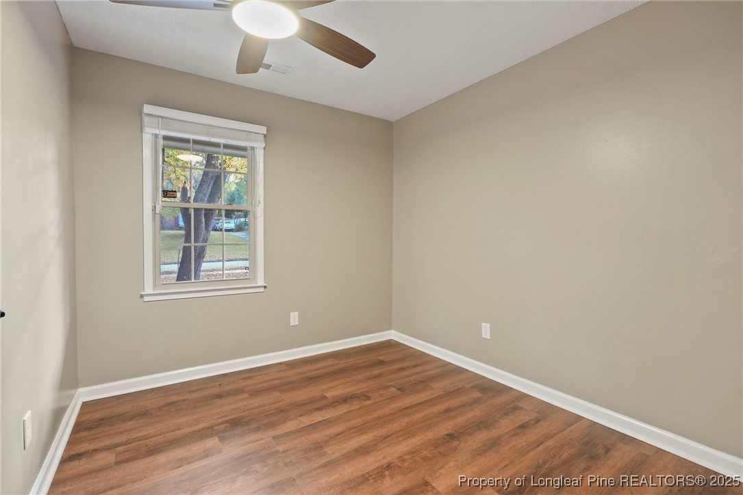 2308 Keith Drive Raleigh, NC 27610 - Photo 9 of 26 a view of an empty room with wooden floor and a window