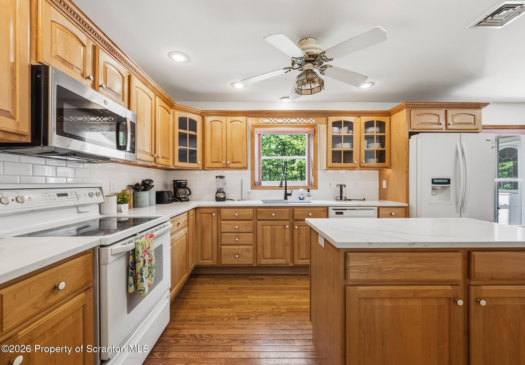 58 Bender Road Gouldsboro, PA 18424 - Photo 9 of 55 a kitchen with stainless steel appliances granite countertop a sink a stove a refrigerator cabinets and a dining table