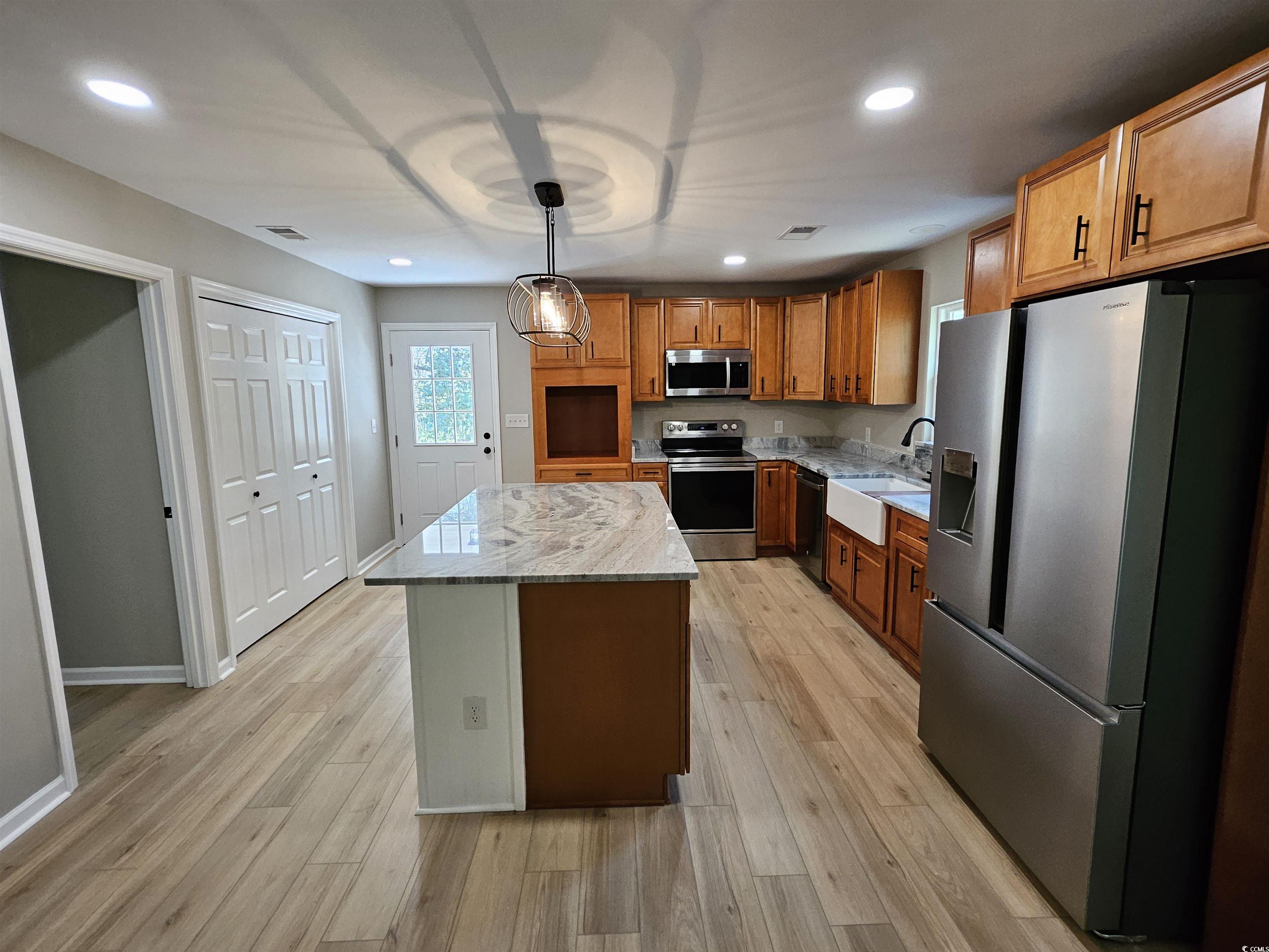 3115 Wayside Road Conway, SC 29527 - Photo 5 of 24 Kitchen with farmhouse sink, light LVP floors and