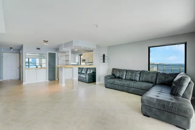 a living room with furniture and kitchen view