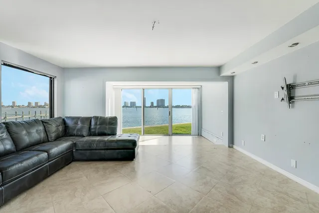 a living room with furniture and a floor to ceiling window