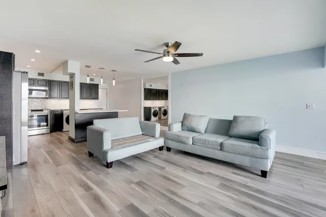 a living room with furniture and a wooden floor