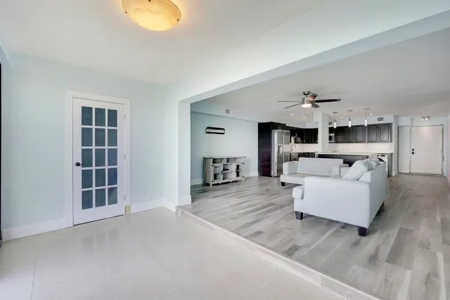 a living room with furniture and a kitchen