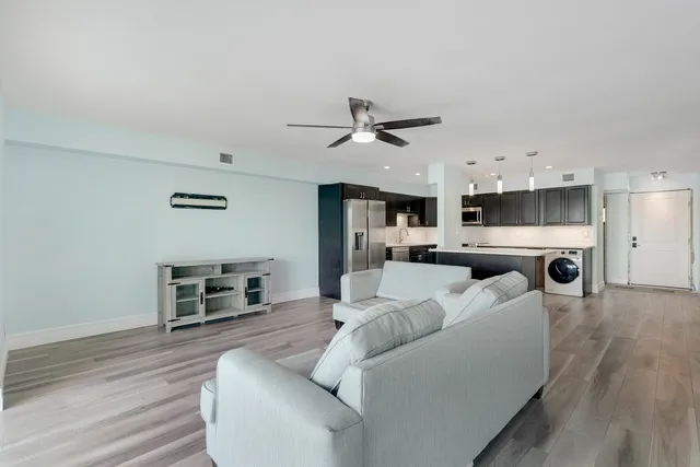 a living room with furniture and kitchen view