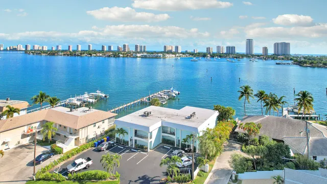 an aerial view of a house with outdoor space and lake view in back